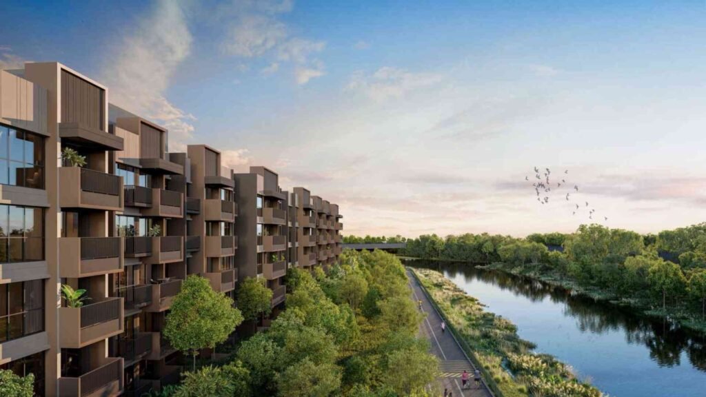 Modern low-rise waterfront condominium with river views and lush greenery, showcasing serene riverside living in Singapore.